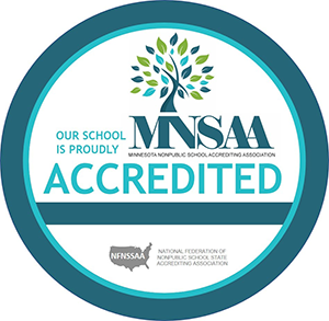 A circular badge with a blue border, containing a tree graphic with multicolored leaves and the text, "Our school is proudly MNSSA Accredited." At the bottom, in smaller text, it reads "Minnesota Nonpublic School Accrediting Association" and "National Federation of Nonpublic School State Accrediting Association." Perfect for your website's footer.