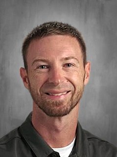 Head shot of a male with short brown hair and short beard